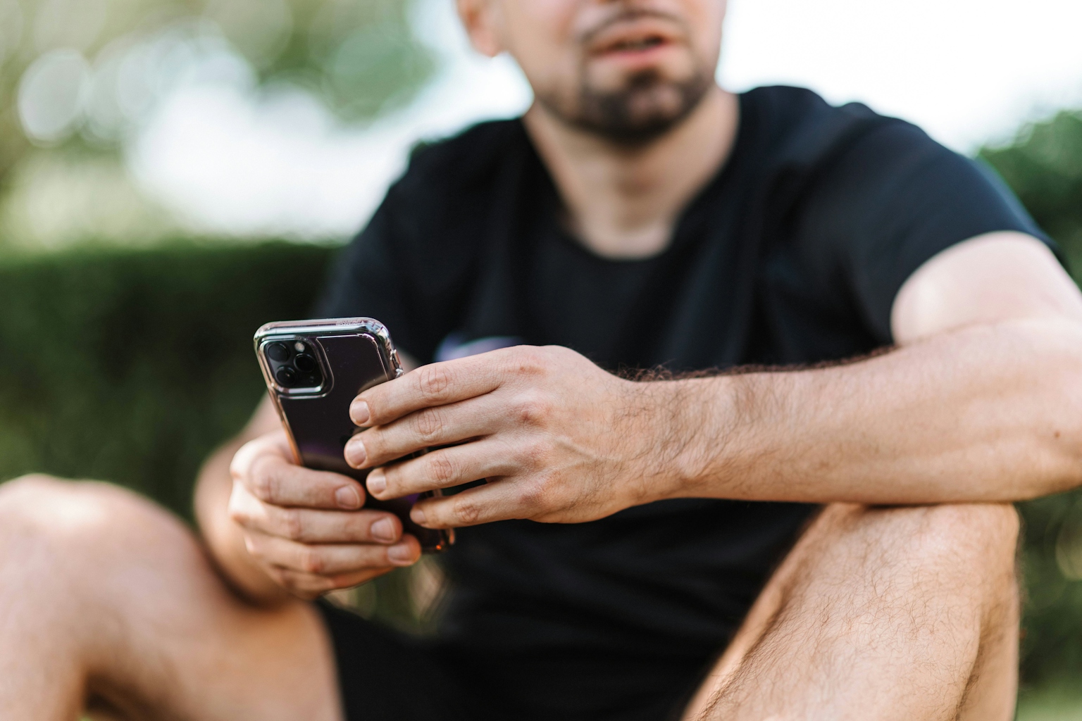 Man sitting with an iphone in his hands.